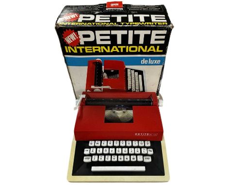 A boxed Petite International de-luxe typewriter