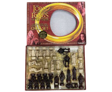A boxed Lord of the Rings: The Two Towers antique ivory and Chinese lacquer-effect finish chess set.
