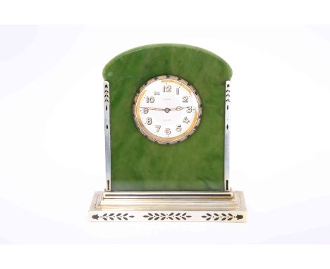 AN ART DECO STERLING SILVER AND NEPHRITE JADE DESK CLOCK, SIGNED CARTIER, the arch topped jade plaque centred by a circular d