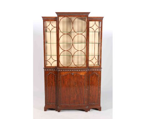 ROBSON, NEWCASTLE UPON TYNEA GEORGE III STYLE MAHOGANY BREAKFRONT CABINET, the upper section with astragal glazing, the base 