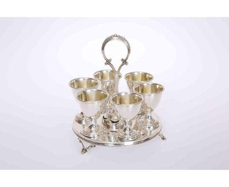 A VICTORIAN SILVER EGG CRUET, Henry Wilkinson &amp; Co, Sheffield 1862, the circular stand with six egg cups, all with beaded