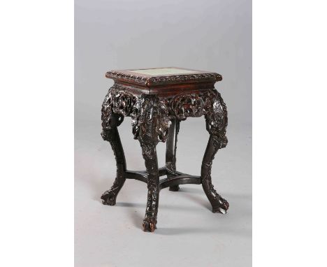 A CHINESE CARVED HARDWOOD JARDINIERE STAND, the square top with leaf-carved edge, the S-scroll legs carved with foliage, join