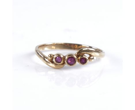 An early 20th century unmarked gold 3-stone ruby crossover ring, setting height 5.1mm, size N, 1.3gGood overall condition, al