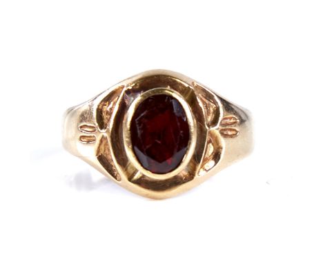 An 18ct gold garnet signet ring, set with oval mixed-cut garnet with decorated shoulders, setting height 14.4mm, size U, 8gVe