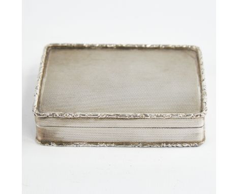 A George V silver snuffbox, plain rectangular form with cast floral border and allover engine turned decoration with gilt int