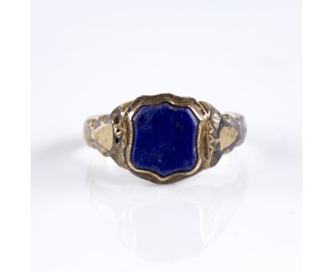 A 19th century gold plated lapis lazuli seal ring, set with shield-shaped seal, with scrollwork shoulders and closed-back set