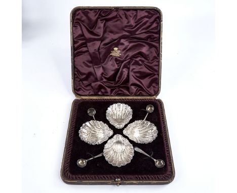 A set of 4 Victorian silver shell salt cellars, with original spoons, relief embossed foliate decoration on bun feet, by Jame