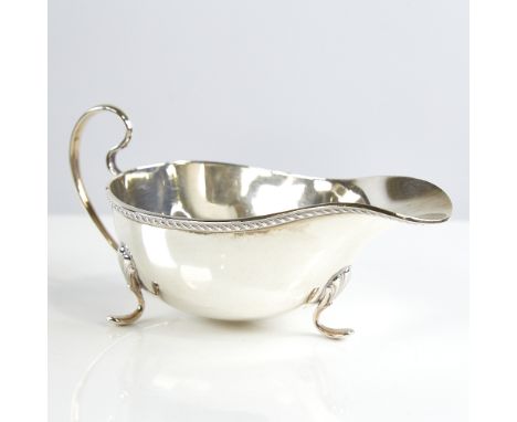 A George V silver sauce boat, gadrooned rim with scrolled acanthus leaf feet, by William Neale & Son Ltd, hallmarks Birmingha