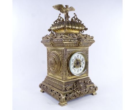 A large 19th century French brass architectural 8-day mantel clock, cream enamel dial with Arabic numerals and elaborate deco