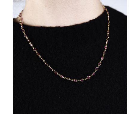 A modern handmade unmarked high carat gold ruby line necklace, set with round-cut rubies, necklace length 46cm, 5gGood origin