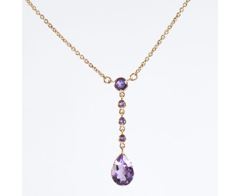 An Edwardian style 9ct gold amethyst line drop pendant necklace, set with round and pear-cut amethysts, on a 9ct chain, hallm
