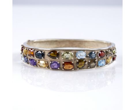 A modern handmade sterling silver gem set hinged bangle, gemstones include citrine amethyst, smoky quartz, topaz, garnet, per