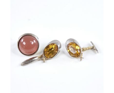 A pair of novelty unmarked white metal and citrine jockey cap cufflinks, cap length 32.5mm, and an unmarked white metal pink 