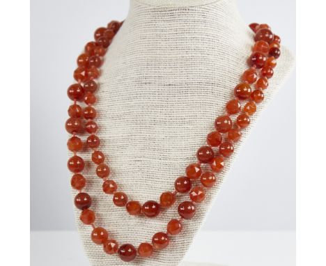 A long Vintage graduated faceted and polished carnelian bead necklace, alternating bead styles, largest diameter 15.5mm, neck
