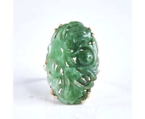 A large late 20th century 9ct gold jade panel ring, carved and pierced floral decoration, panel length 29.1mm, size N, 7gVery