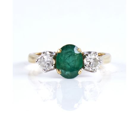 A mid-20th century unmarked high carat gold 3-stone emerald and diamond ring, set with oval mixed-cut emerald and round brill