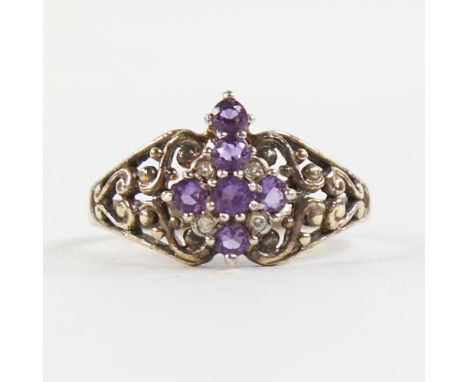 A late 20th century silver-gilt amethyst and diamond cross ring, pierced scrollwork shoulders, setting height 12.9mm, size T,