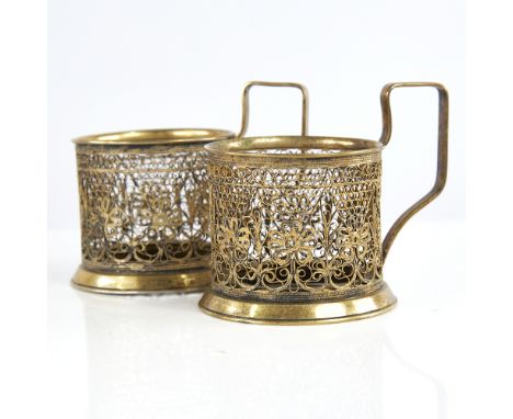 A pair of Russian unmarked gilt white metal tea glass holders, allover filigree wirework decoration, stamped Iomimet 1 Copt, 
