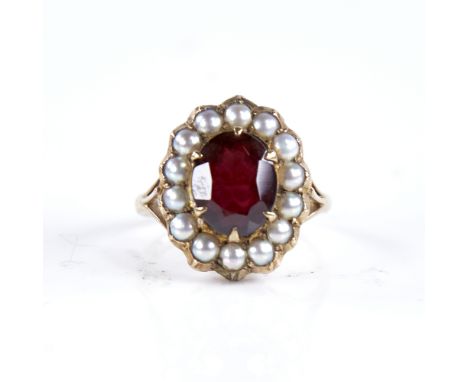 A late 20th century 9ct gold garnet and split-pearl cluster ring, set with oval mixed-cut garnet with openwork bridge, settin