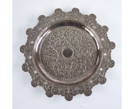 A late 19th/early 20th century Indian unmarked white metal pin dish, allover relief embossed foliate decoration with chased t