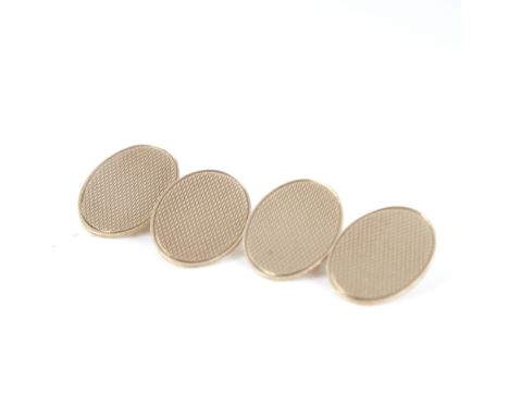 A mid-20th century pair of 9ct gold cufflinks, oval panels with engine turned decoration, hallmarks London 1946, panel length