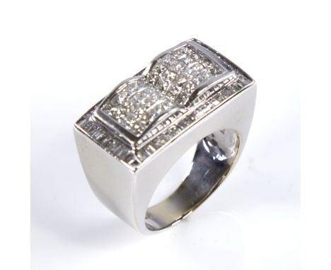 A large modern heavy 18ct white gold diamond cluster ring, pave set with Princess and tapered baguette-cut diamonds, total di