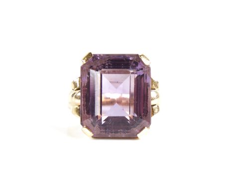A large late 20th century 9ct gold step-cut amethyst ring, openwork lozenge bridge with raised shoulders, amethyst length 16.