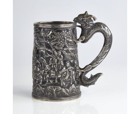 A mid-19th century Chinese export silver mug, by Cutshing of Canton, tapered cylindrical form with relief embossed figural sc