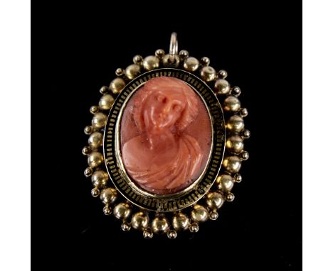 A Victorian relief carved coral cameo pendant, depicting Classical female bust, in unmarked gold and black enamel frame, pend