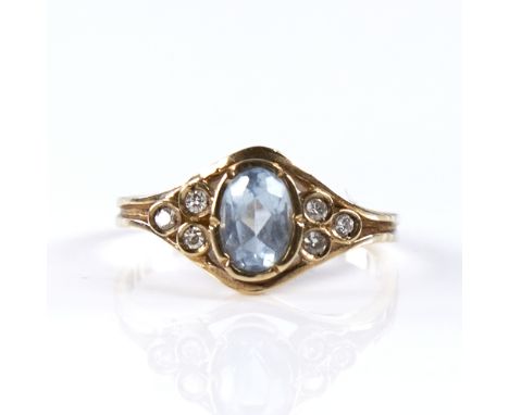 A modern 9ct gold aquamarine and diamond dress ring, set with oval mixed-cut aqua and round brilliant-cut diamonds, total dia