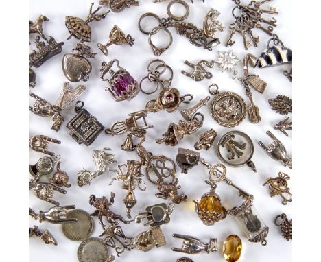 A large quantity of various silver and unmarked charms and fobs, including teapot, animals, cherubs, clock, love heart etc, 1