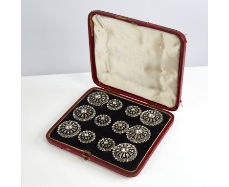 A set of 12 Georgian unmarked silver and colourless paste dress buttons, pierced sunburst design with closed backs, largest d