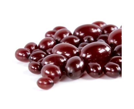 A group of loose cherry amber beads, bead lengths ranging from 24mm to 11mm, 55.2g total All in good overall condition, light