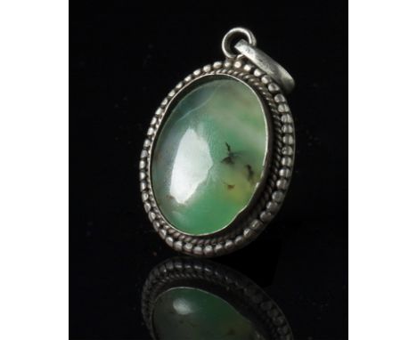 A jade pendant China, 20th Century White-green jade set within a silver frame. lxhxp 4,5 cm Start Price: €10