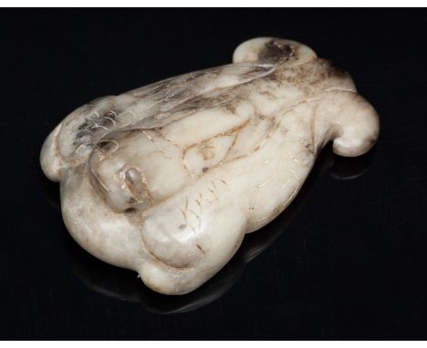 A Chinese jade pendant China, Han Dynasty, 1st B.C. An archaic jade pendant representing a stylised animal. lxh 6 x 4 cm Star