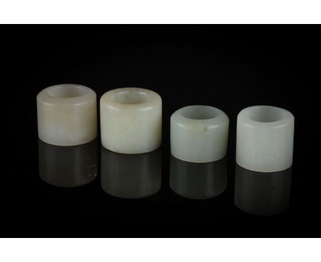 Four jade rings China, Qing Dynasty, 18th Century Four archer&#39;s rings without decoration in a pale green jade. h 2,5 cm S