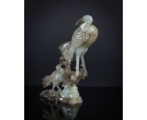 A jade carving China, Qing Dynasty, 19th Century Pale green colour depicting two birds. h 23 cm Start Price: €400