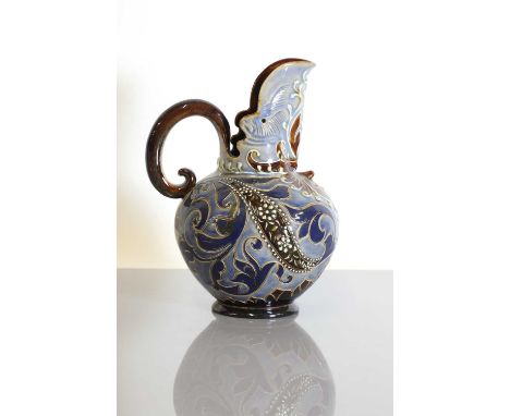 A Doulton Lambeth stoneware ewer, by Mark V Marshall, of squat form incised and jewelled with scrolling foliage, with a smili