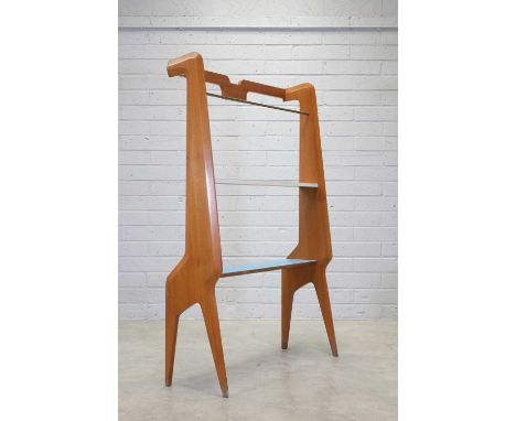 An Italian free-standing 'Giraffe' teak bookshelf,1960s, in the manner of Ico Parisi, with a brass top rail, leading to a blu