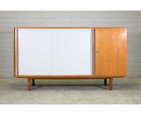 A French oak sideboard, 1950s, in the manner of Charlotte Perriand, the front with a pair of white laminate doors on rails, e