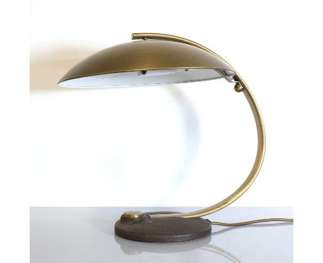 A German brass table lamp,1970s, designed by Egon Hillebrand, with a conforming dish-shaped shade raised on a curved arm, wit