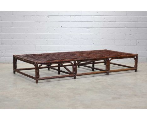 A stained bamboo and rattan daybed, 1970s, of low rectangular form, 190cm wide91cm deep31cm high