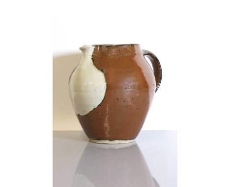Shoji Hamada (Japanese, 1894-1978),a studio pottery ewer, of ovoid form, decorated with an iron glaze, to the front with a fi