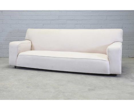 An Art Deco sofa,1930s, designed by Betty Joel for Tokenworks, upholstered in white cotton with piped edges, with a single cu