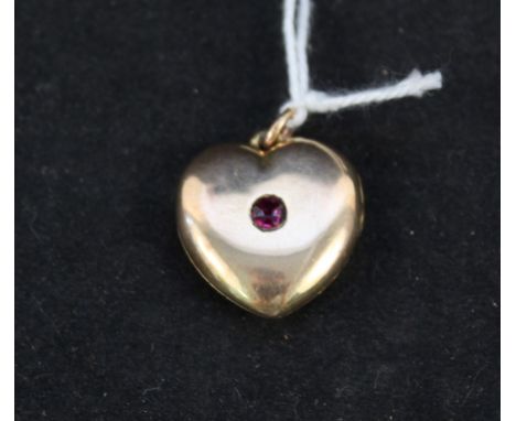 A yellow metal heart shaped photo locket set with red stone inscribed Ruby to reverse