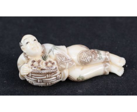 A Japanese ivory netsuke of a boy with raised hand, signed