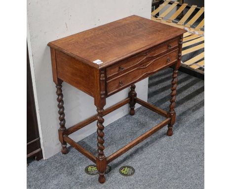 An early 20th century oak two drawer side table raised on barley twist supports, 70cm by 42cm by 76cm, a walnut cheval dressi