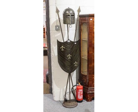 A novelty standard lamp formed from a shield, cross spears and a knights helmet, 178cm high
