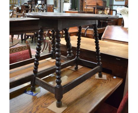 A 19th century provincial oak table on bobbin turned supports, with a rotating drop-leaf top, 66cm by 56cm