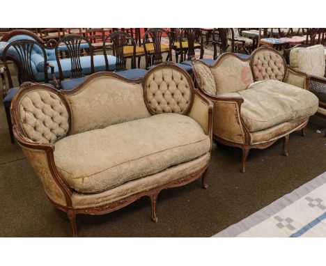 A pair of early 20th century French style carved settees of tub form, with button backs and raised on scroll supports (2)